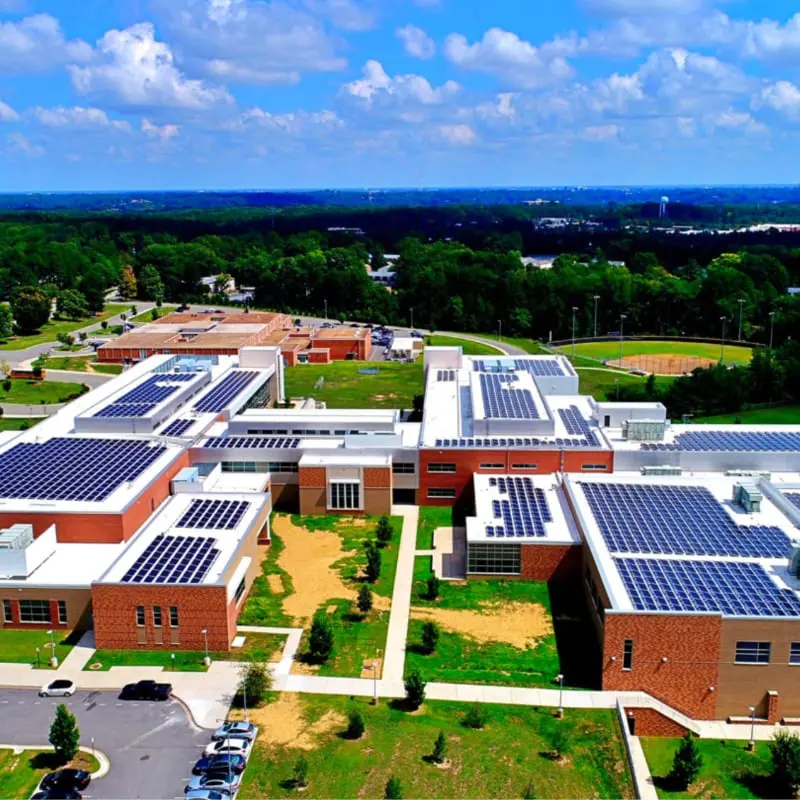 Aerial view of rooftop solar panels on a school campus
